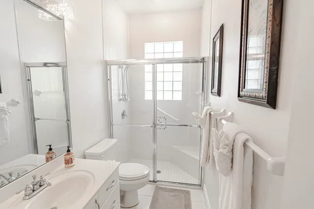 a bathroom with a shower toilet and sink