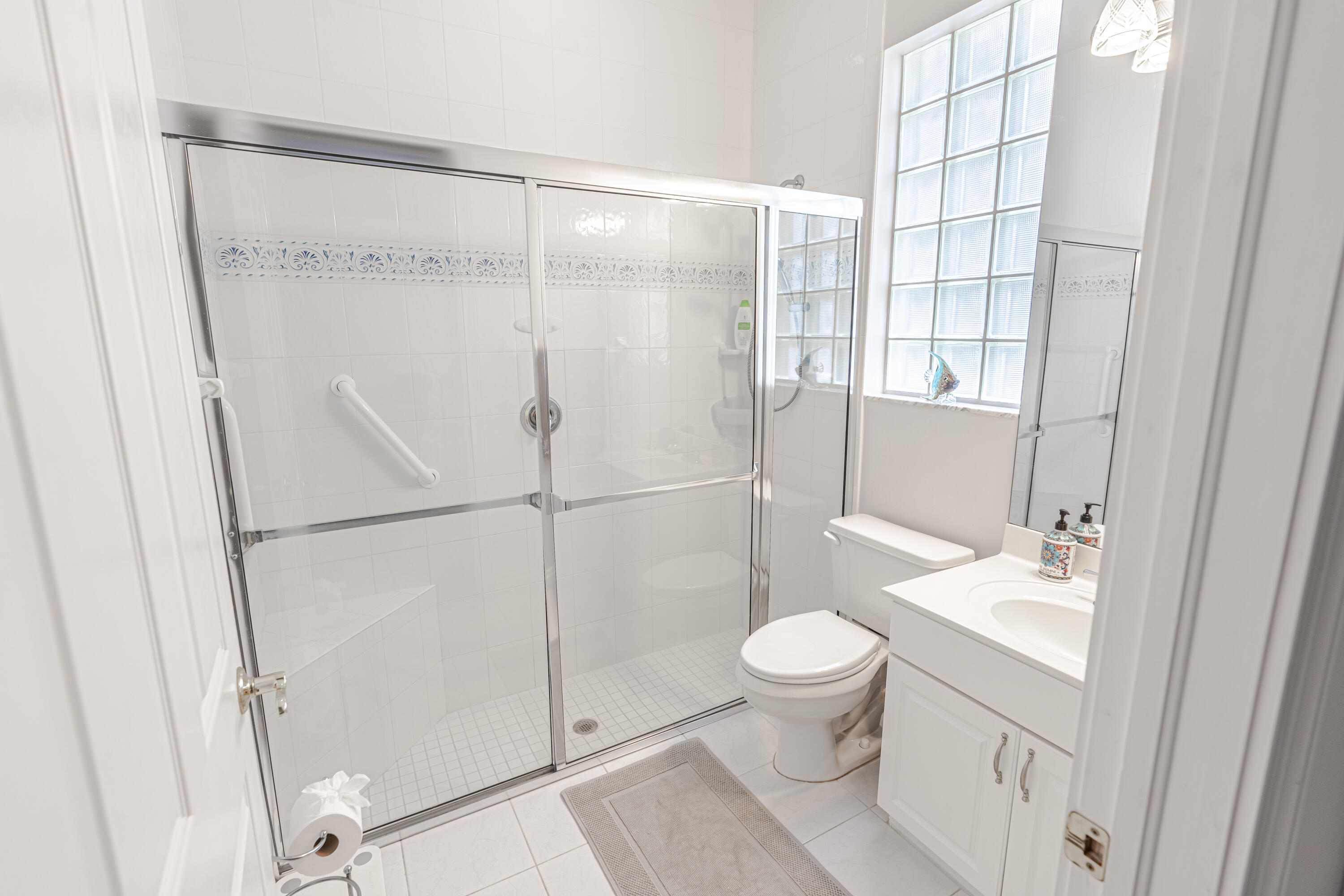 15350 Take Off Place Wellington, FL 33414 - Photo 35 of 44 a bathroom with a shower toilet and sink