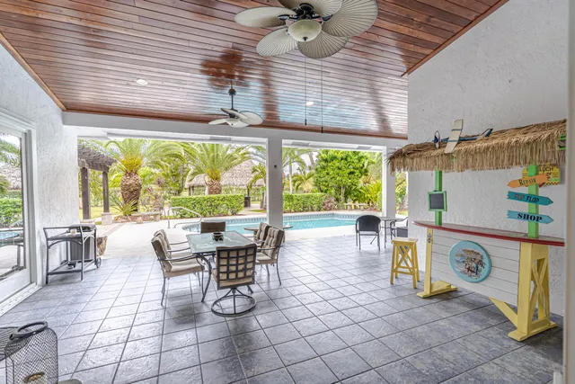 a view of a dining room with furniture a chandelier and wooden floor