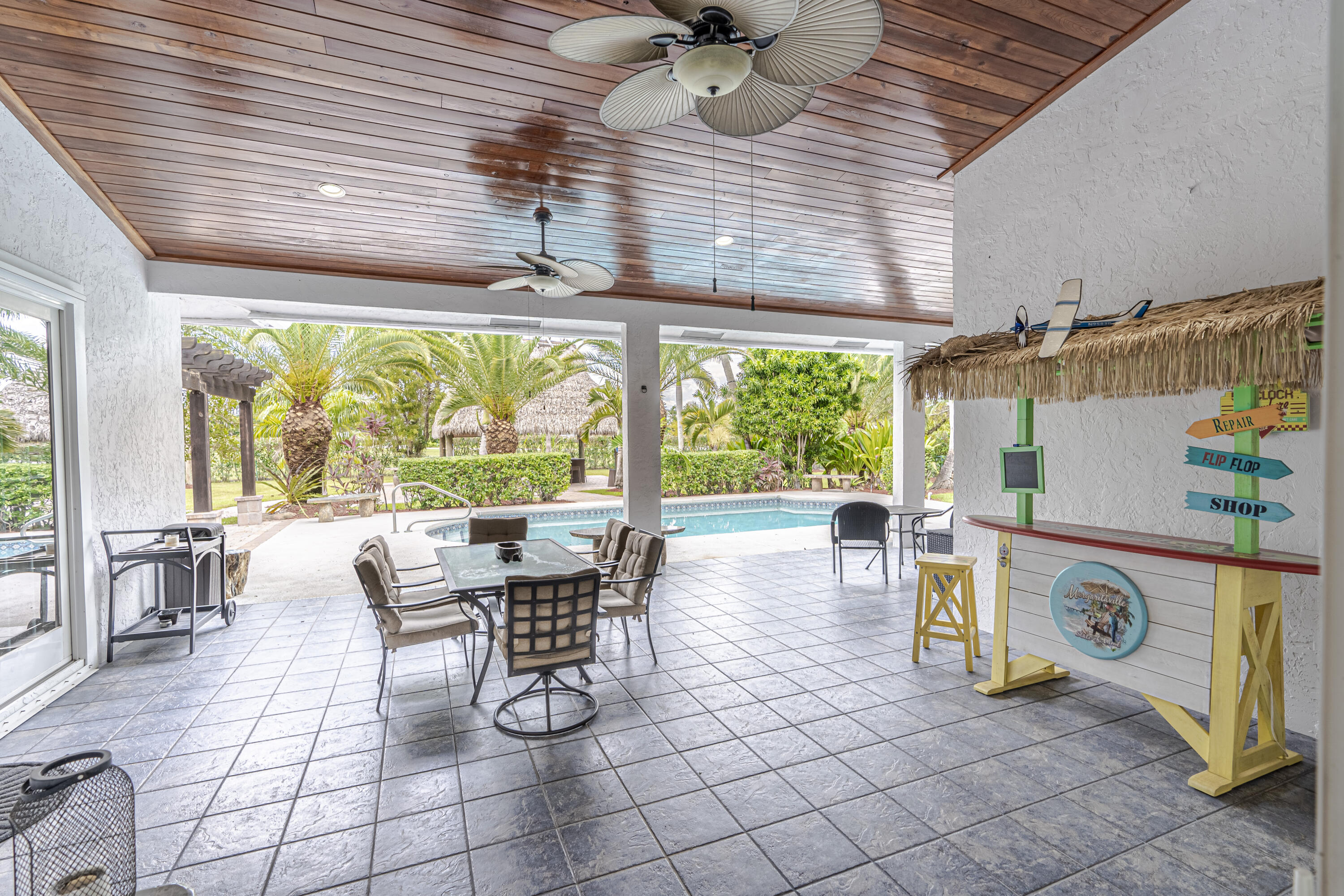 15350 Take Off Place Wellington, FL 33414 - Photo 36 of 44 a dining room with furniture and a floor to ceiling window