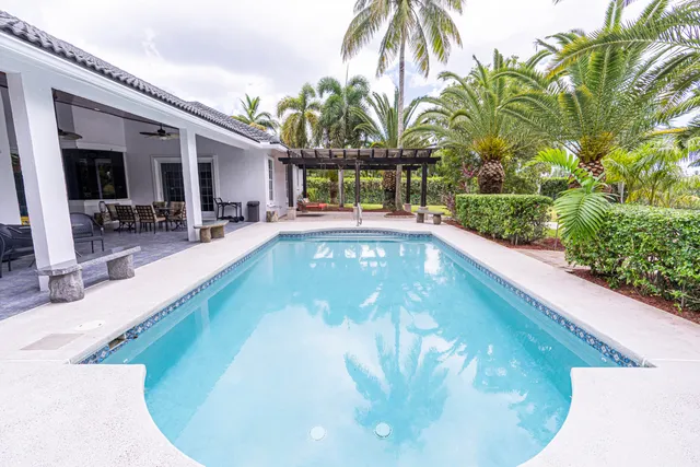 a view of yard with swimming pool and sitting area