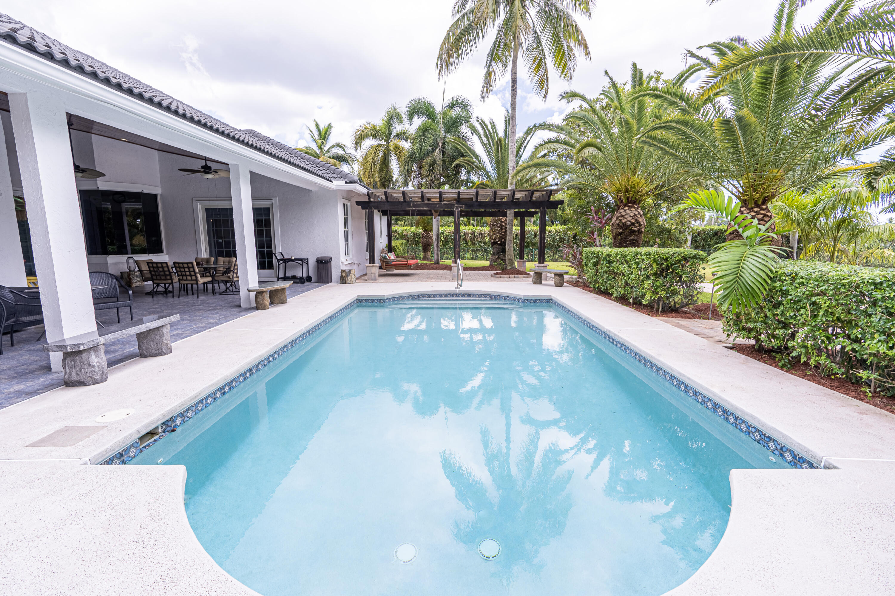 15350 Take Off Place Wellington, FL 33414 - Photo 38 of 44 a view of a swimming pool with a patio