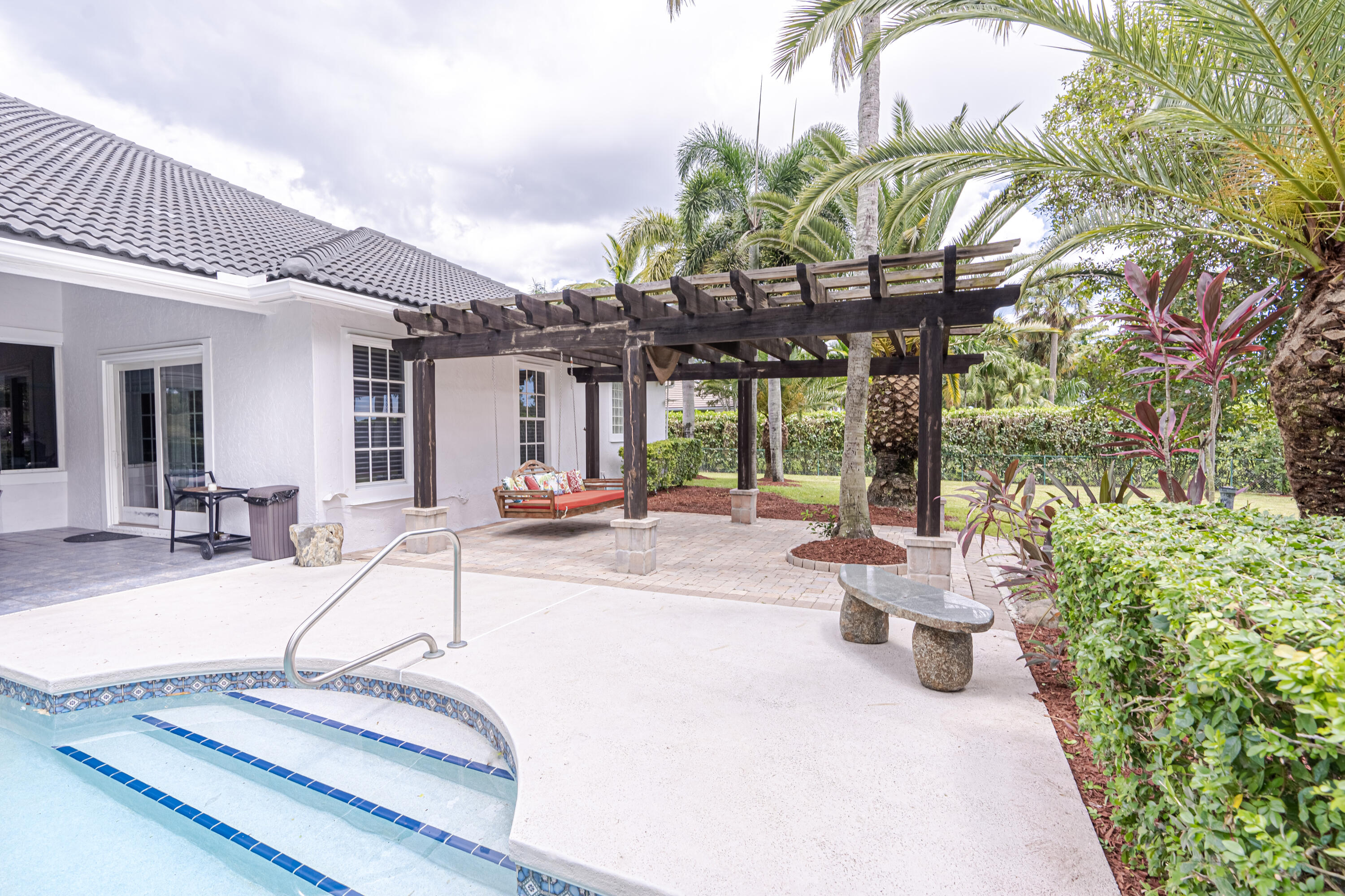 15350 Take Off Place Wellington, FL 33414 - Photo 40 of 44 a view of a patio with table and chairs potted plants and large tree