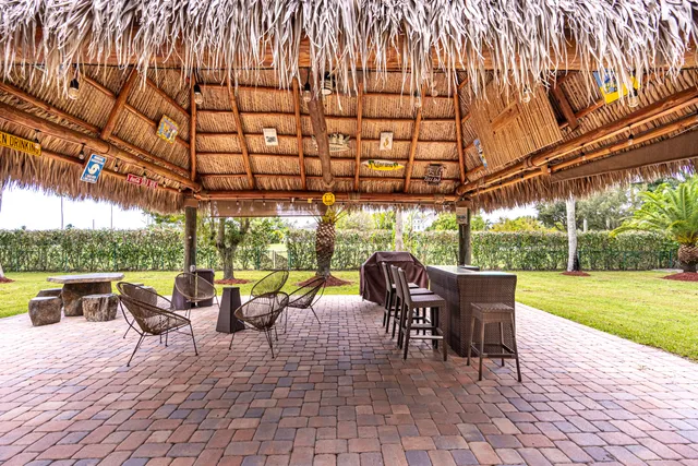 a swimming pool with outdoor seating and yard