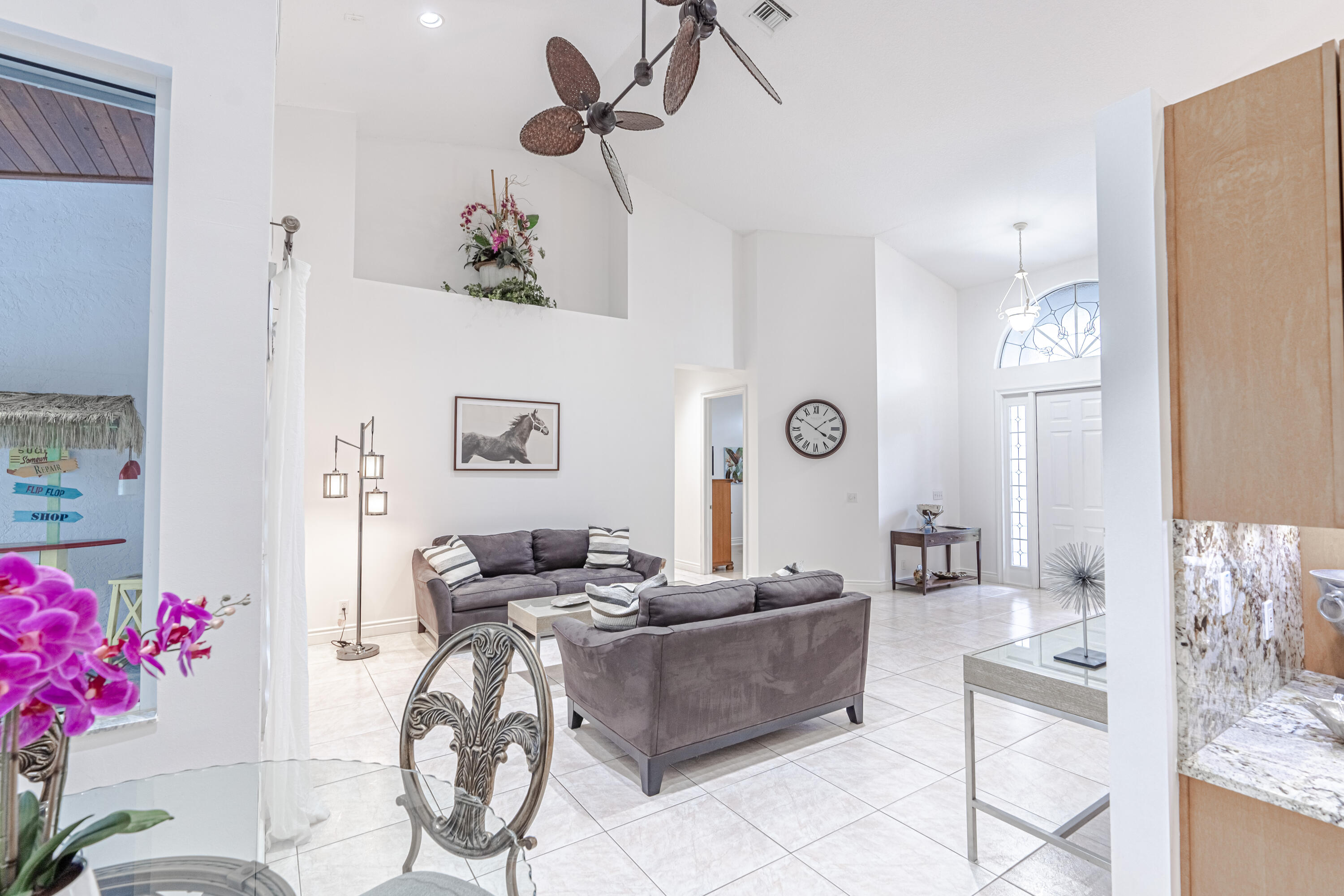 15350 Take Off Place Wellington, FL 33414 - Photo 5 of 44 a living room with furniture and a chandelier
