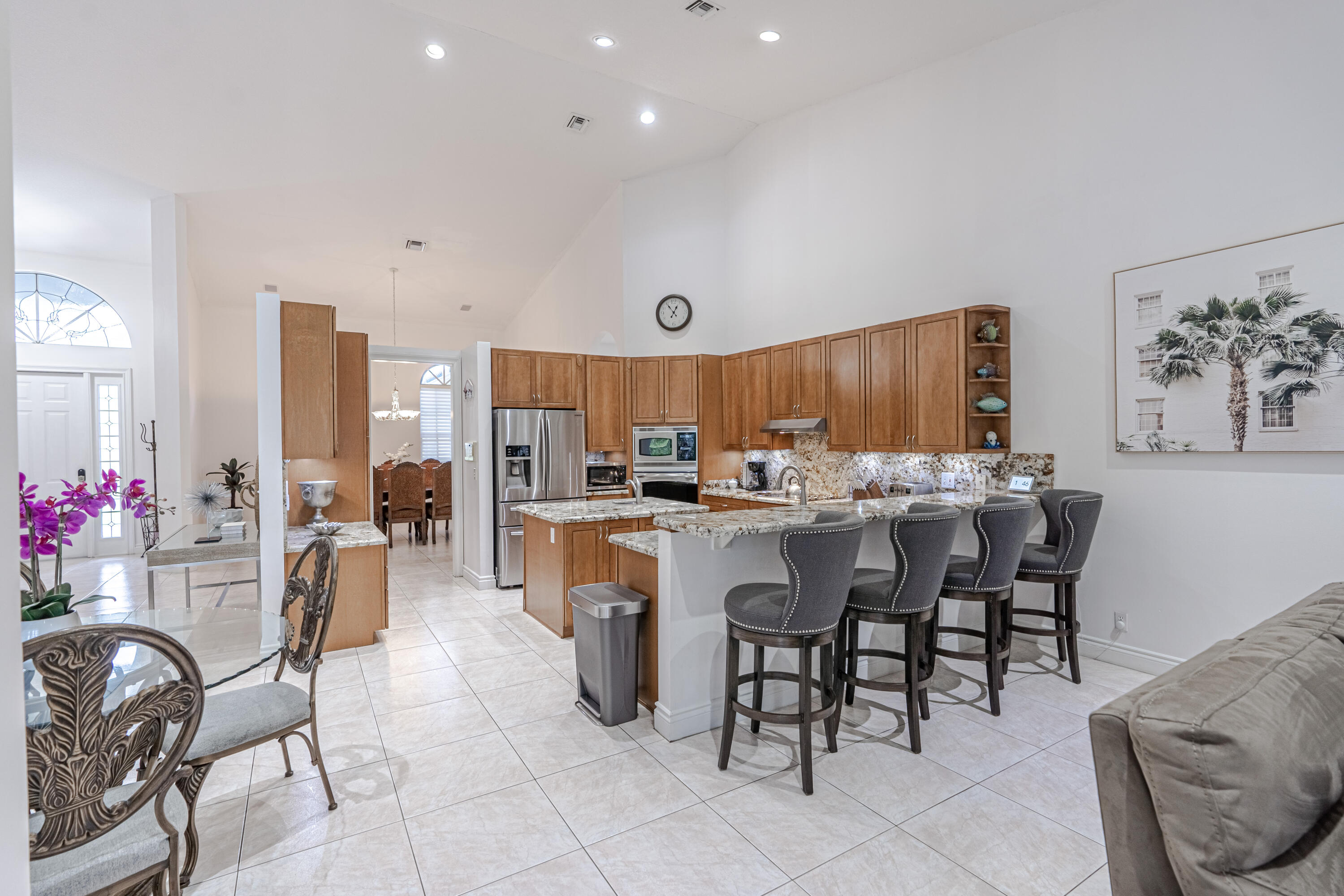 15350 Take Off Place Wellington, FL 33414 - Photo 8 of 44 a kitchen with granite countertop a table and chairs