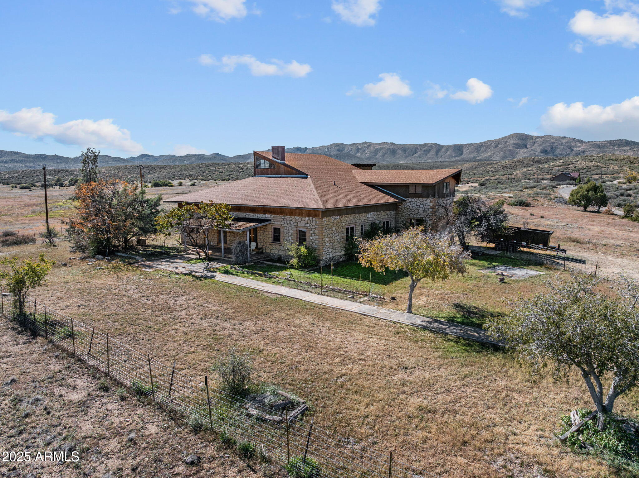 a view of a house with a yard and mountain