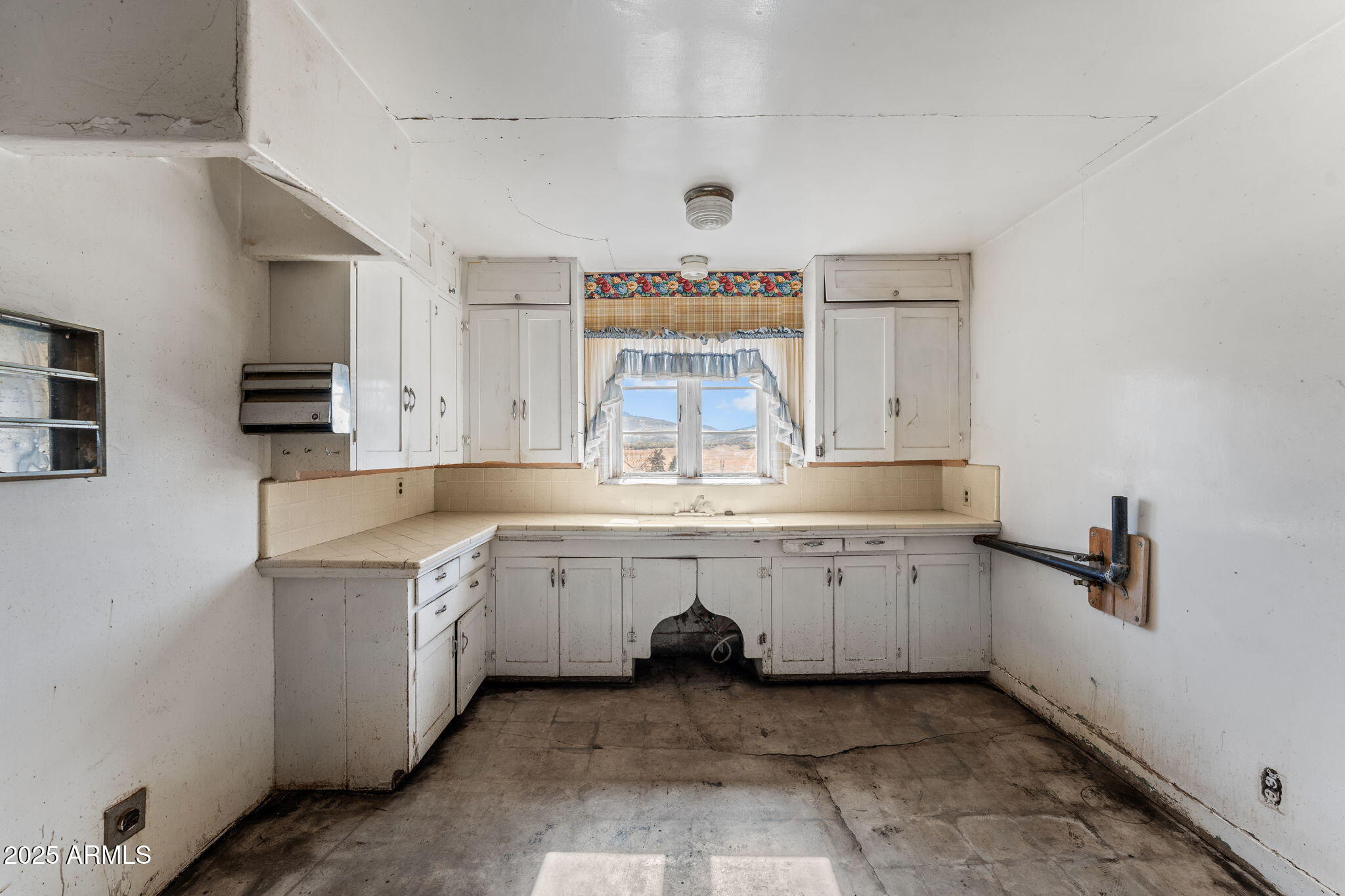 16057 Sickles Ranch Road Peeples Valley, AZ 86332 - Photo 14 of 40 a large white kitchen with a stove a sink dishwasher and cabinets