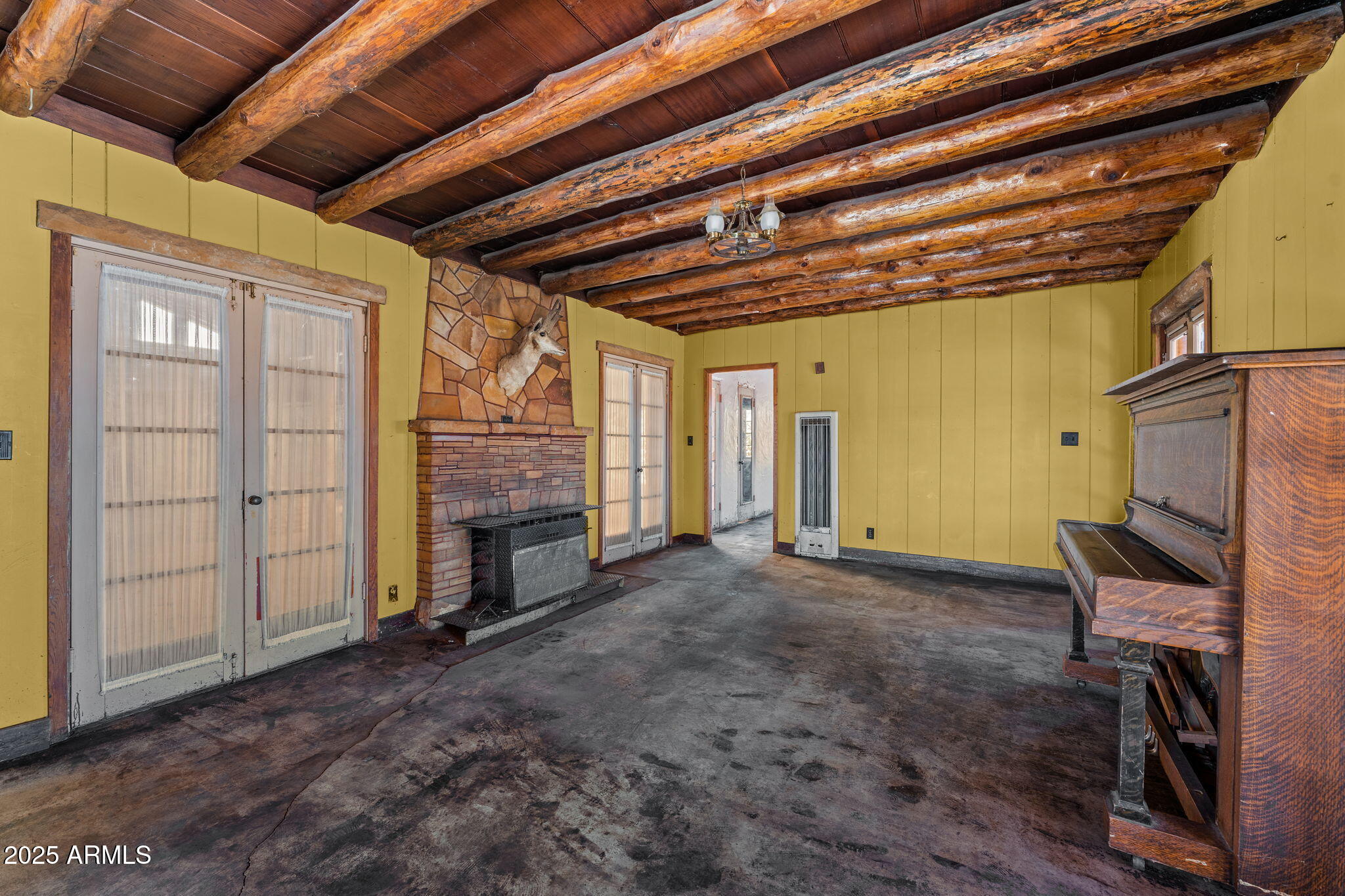 16057 Sickles Ranch Road Peeples Valley, AZ 86332 - Photo 9 of 40 a view of empty room with wooden floor and fireplace