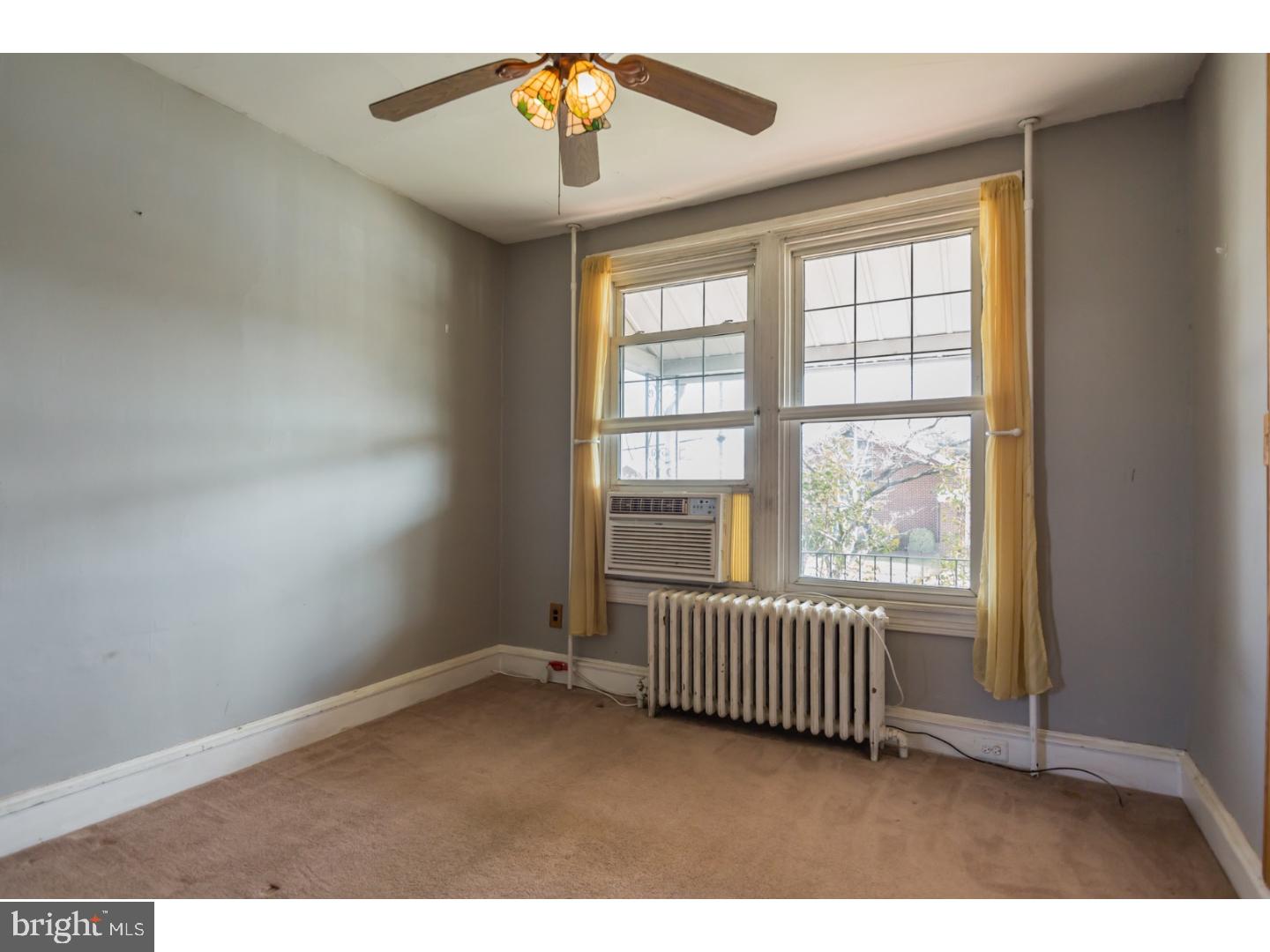116 Warwick Road Magnolia, NJ 08049 - Photo 4 of 24 an empty room with windows and ceiling fan