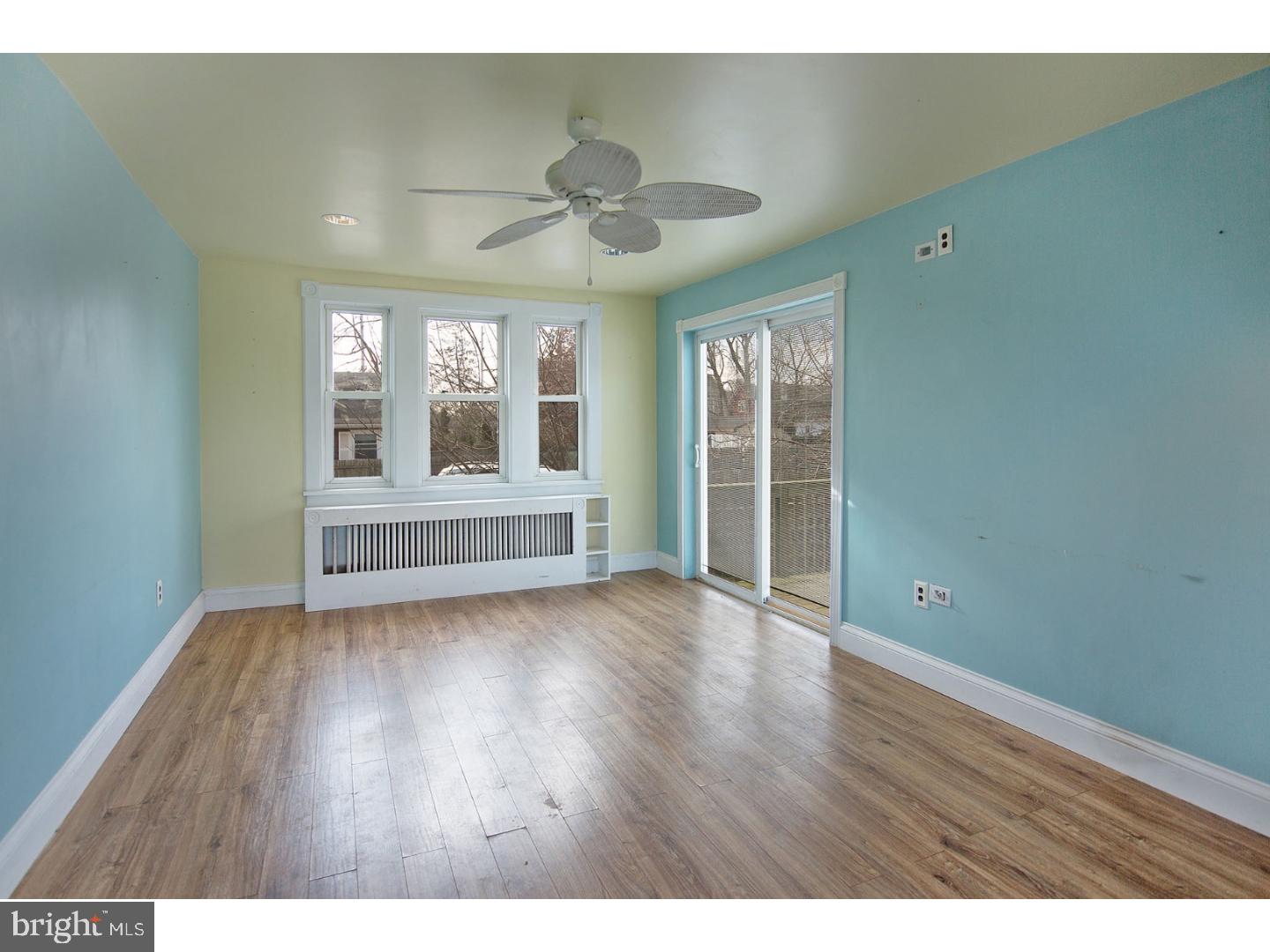 116 Warwick Road Magnolia, NJ 08049 - Photo 9 of 24 a view of an empty room with wooden floor and a window