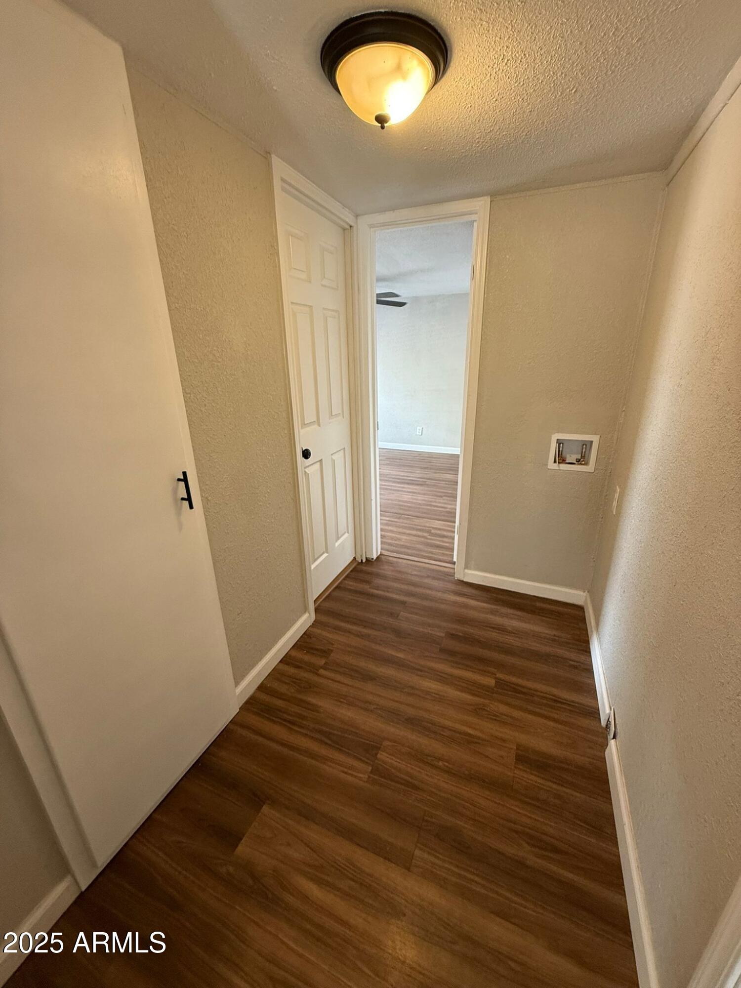 2303 East Carnation Street Douglas, AZ 85607 - Photo 11 of 16 a view of a hallway with wooden floor