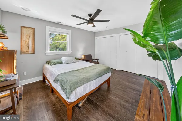 a bedroom with a bed and a potted plant on the table