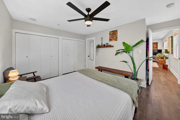 a bedroom with a bed and a painting on the wall