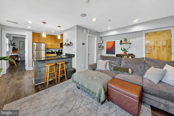 a living room with furniture and kitchen view