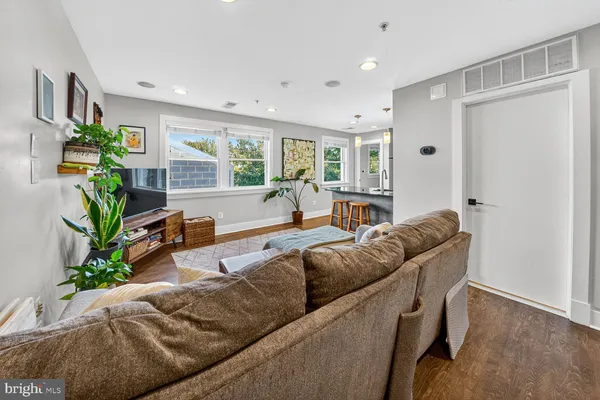 a living room with furniture and a potted plant