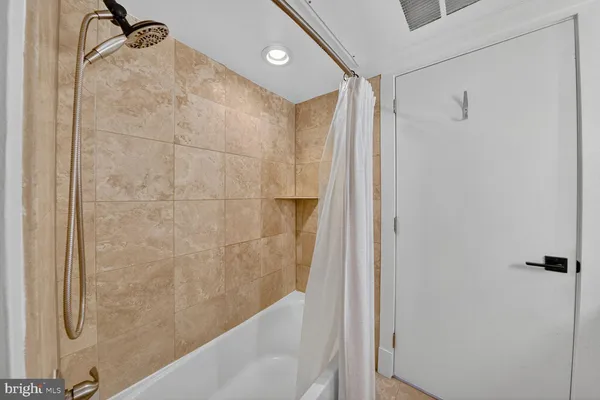 a bathroom with a shower and a glass door