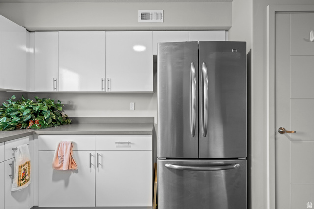 64 West 600 South, Unit C205 Springville, UT 84663 - Photo 12 of 28 Kitchen featuring freestanding refrigerator, white cabinetry, and light countertops