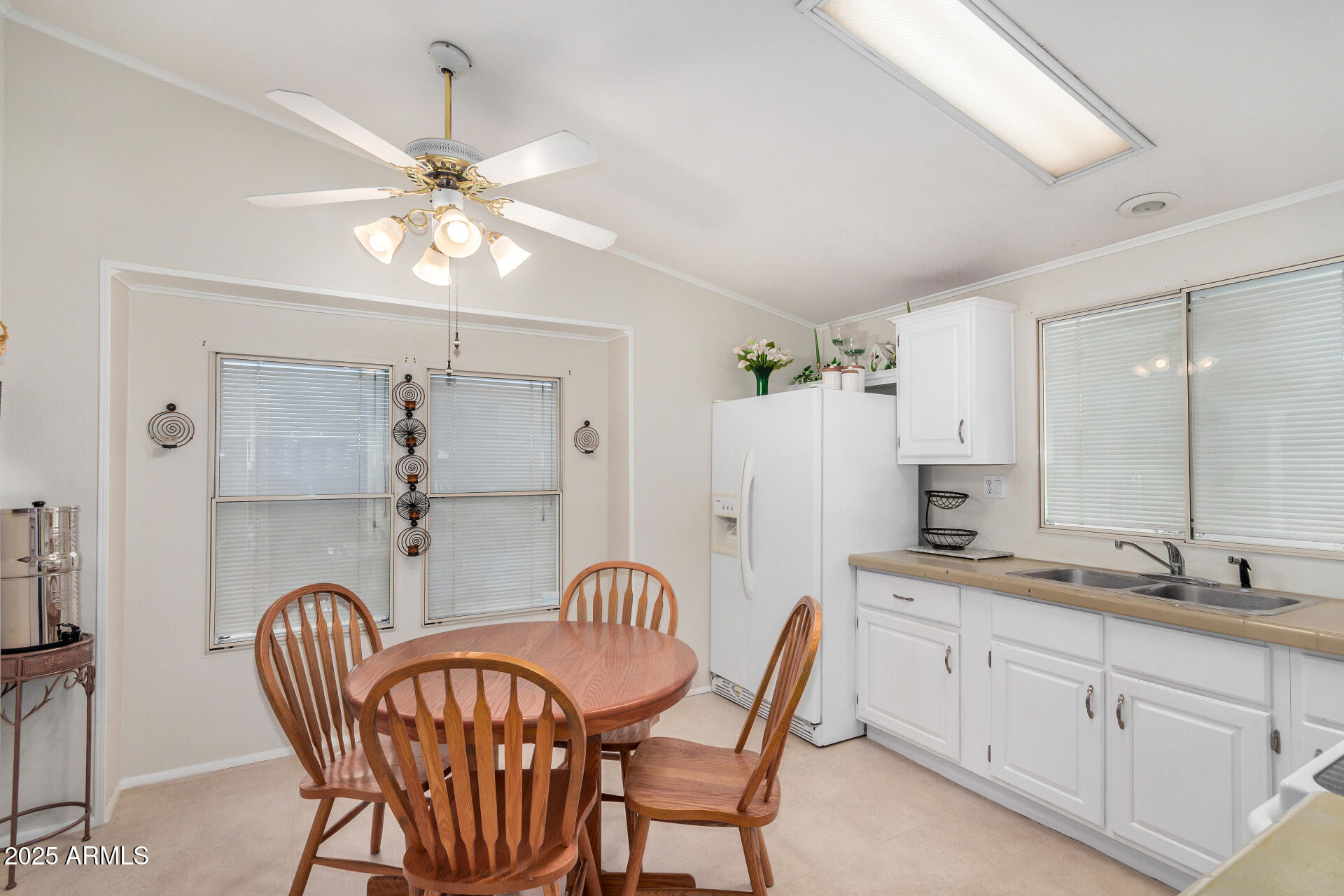 2208 West Baseline Avenue, Unit 114 Apache Junction, AZ 85120 - Photo 12 of 28 a dining room with furniture and chandelier