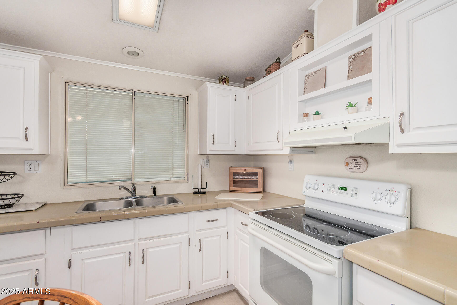 2208 West Baseline Avenue, Unit 114 Apache Junction, AZ 85120 - Photo 14 of 28 a kitchen with cabinets appliances a sink and a counter top