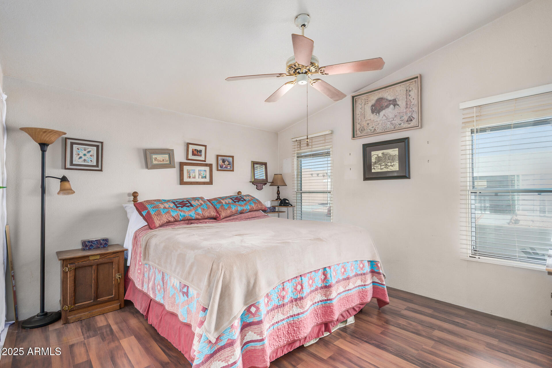 2208 West Baseline Avenue, Unit 114 Apache Junction, AZ 85120 - Photo 16 of 28 a bedroom with a bed and a chandelier