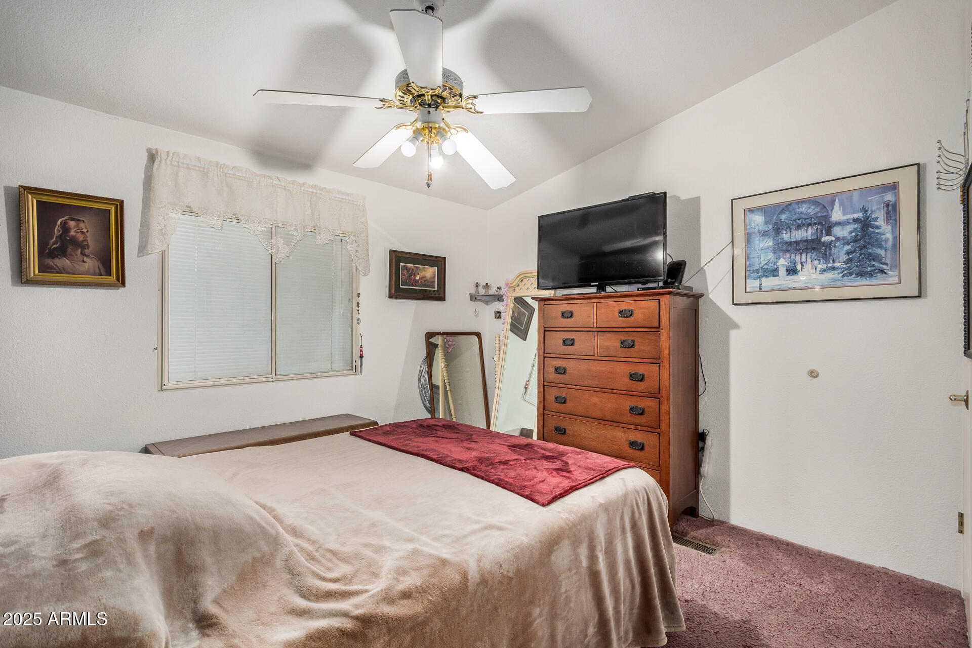 2208 West Baseline Avenue, Unit 114 Apache Junction, AZ 85120 - Photo 18 of 28 a bedroom with a bed and a flat screen tv