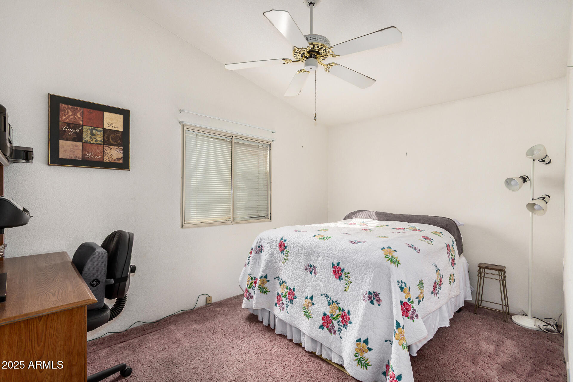 2208 West Baseline Avenue, Unit 114 Apache Junction, AZ 85120 - Photo 20 of 28 a bedroom with a bed and a chandelier