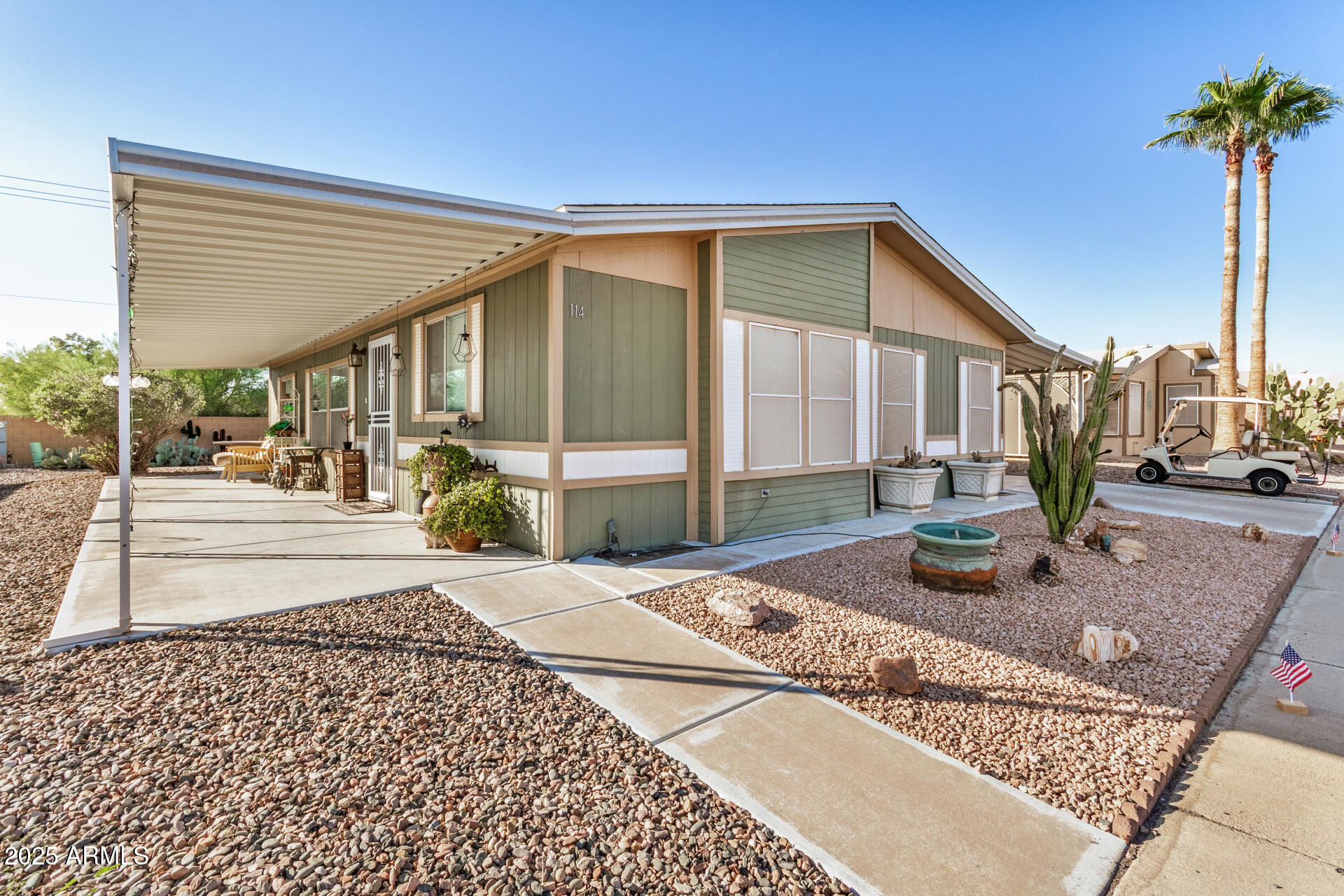 2208 West Baseline Avenue, Unit 114 Apache Junction, AZ 85120 - Photo 2 of 28 a front view of a house with garden