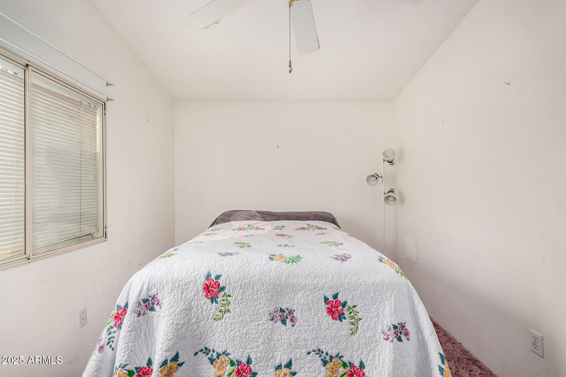 2208 West Baseline Avenue, Unit 114 Apache Junction, AZ 85120 - Photo 21 of 28 a white bed sitting in a bedroom next to a window