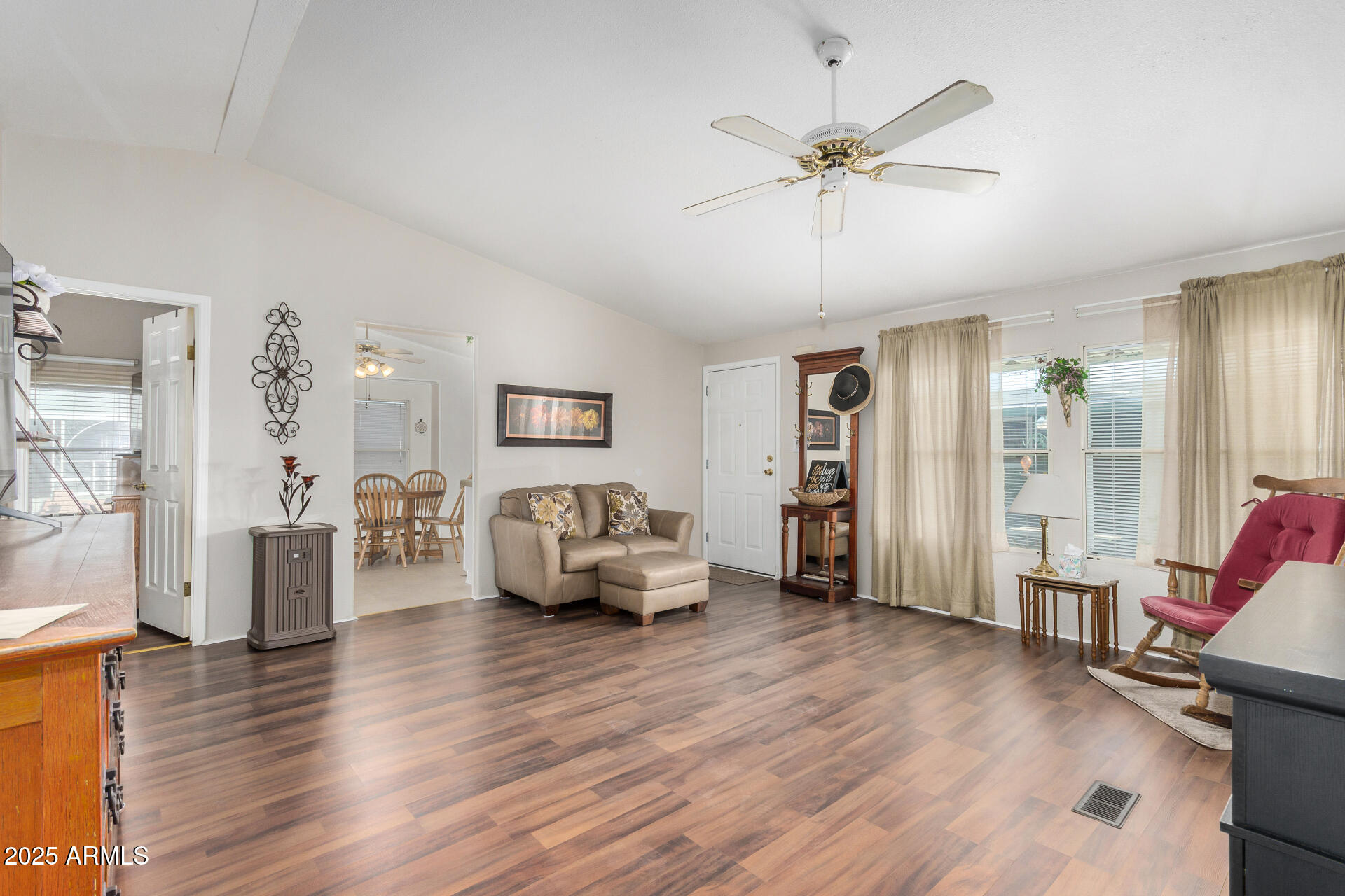 2208 West Baseline Avenue, Unit 114 Apache Junction, AZ 85120 - Photo 9 of 28 a living room with furniture and a wooden floor