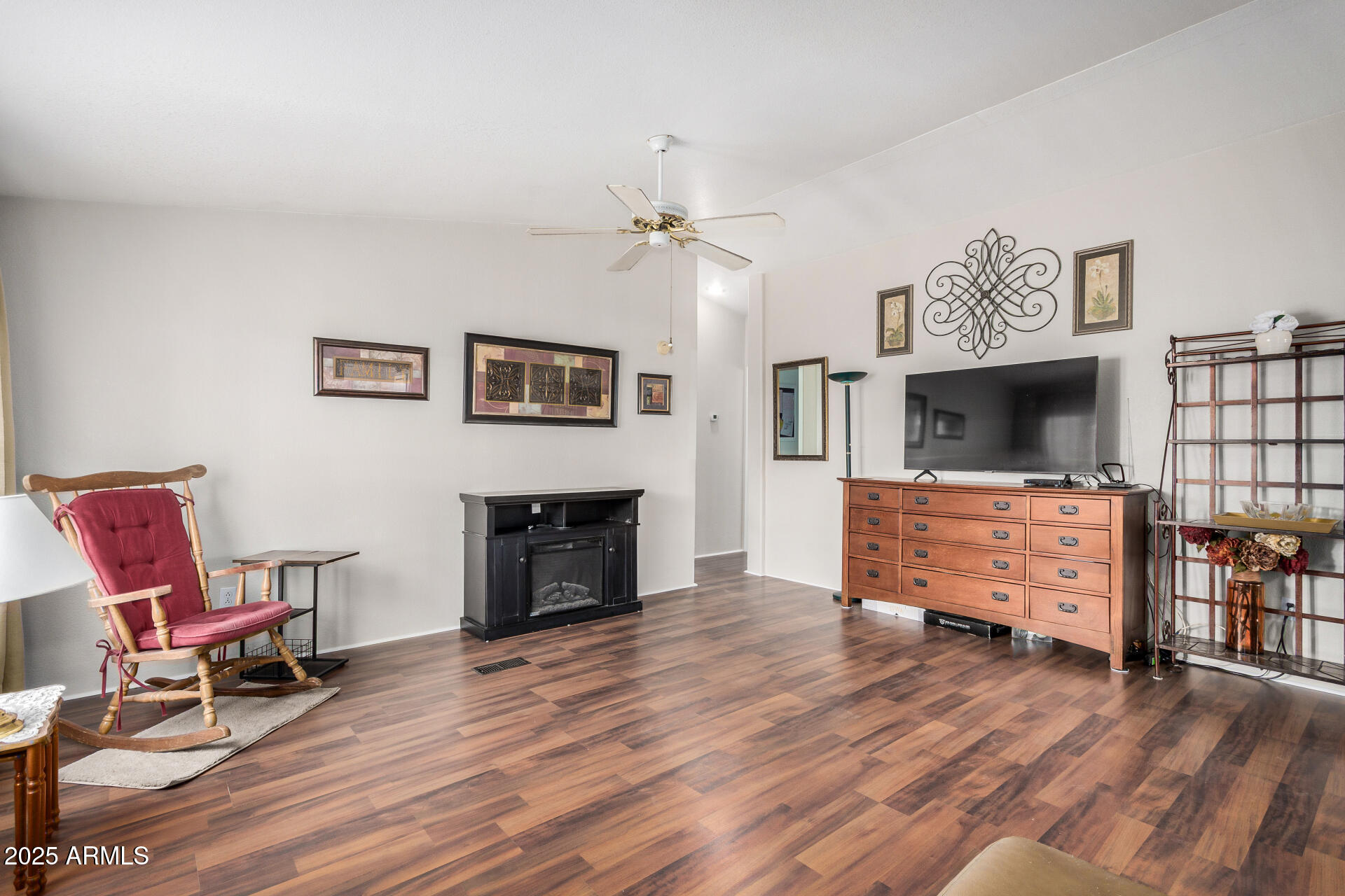2208 West Baseline Avenue, Unit 114 Apache Junction, AZ 85120 - Photo 10 of 28 a living room with furniture a fireplace and a flat screen tv