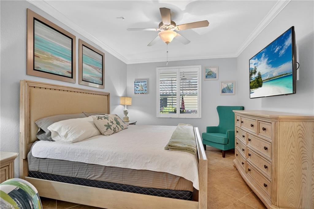 9513 Avellino Way, Unit 2014 Naples, FL 34113 - Photo 13 of 41 a bedroom with a bed dresser and wooden floor