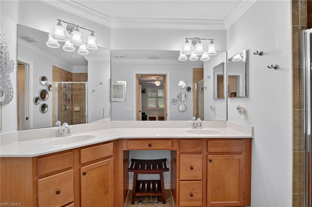 9513 Avellino Way, Unit 2014 Naples, FL 34113 - Photo 15 of 41 a bathroom with a granite countertop double vanity sink and a mirror