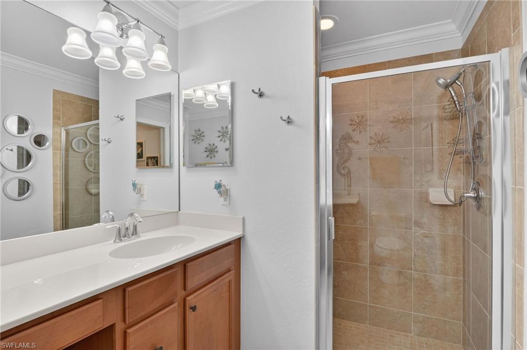 9513 Avellino Way, Unit 2014 Naples, FL 34113 - Photo 16 of 41 a bathroom with a sink vanity granite shower and a mirror