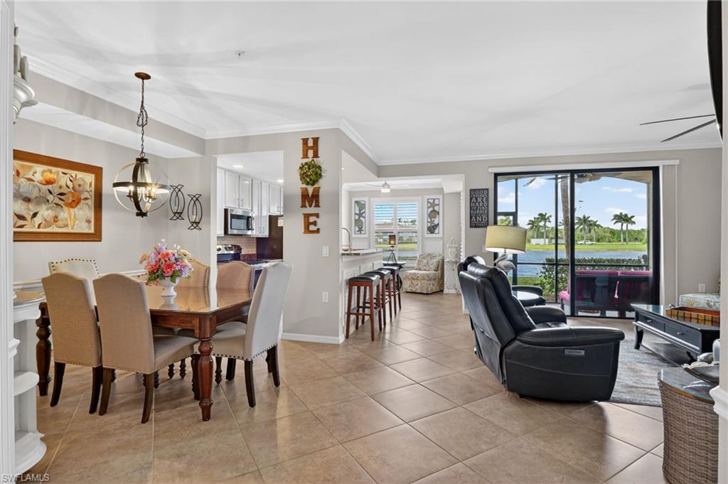 9513 Avellino Way, Unit 2014 Naples, FL 34113 - Photo 19 of 41 a dining room with furniture and a floor to ceiling window