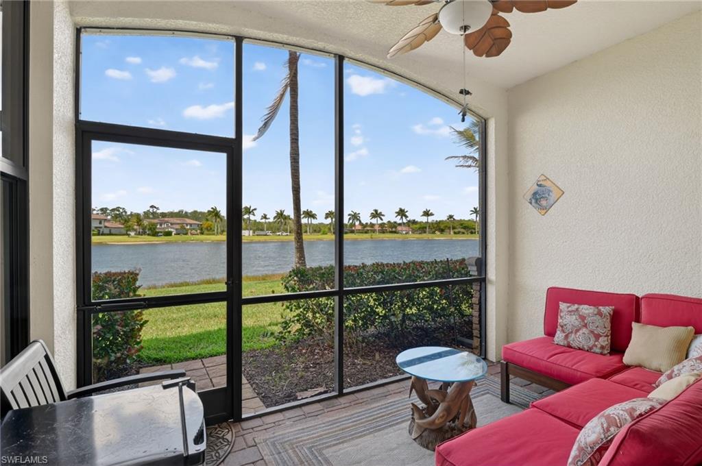 9513 Avellino Way, Unit 2014 Naples, FL 34113 - Photo 2 of 41 a balcony with furniture and a floor to ceiling window