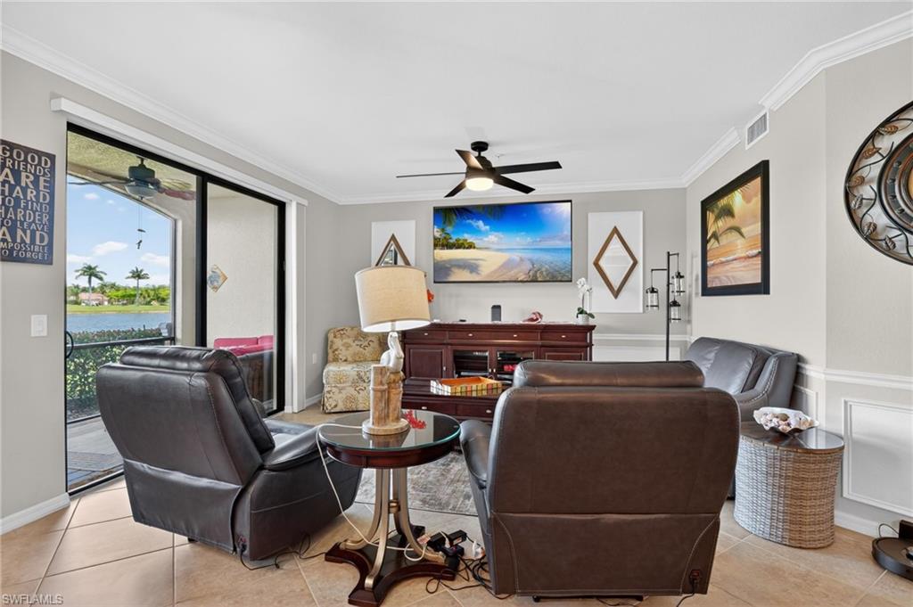 9513 Avellino Way, Unit 2014 Naples, FL 34113 - Photo 25 of 41 a living room with furniture a flat screen tv and a window