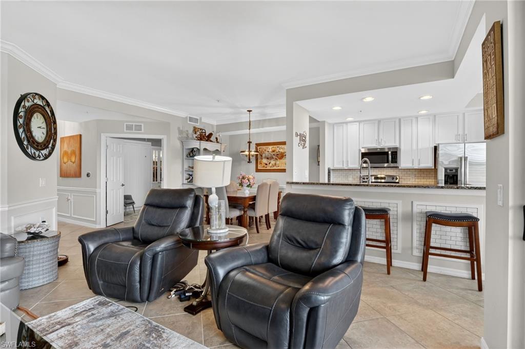 9513 Avellino Way, Unit 2014 Naples, FL 34113 - Photo 26 of 41 a living room with furniture and kitchen view