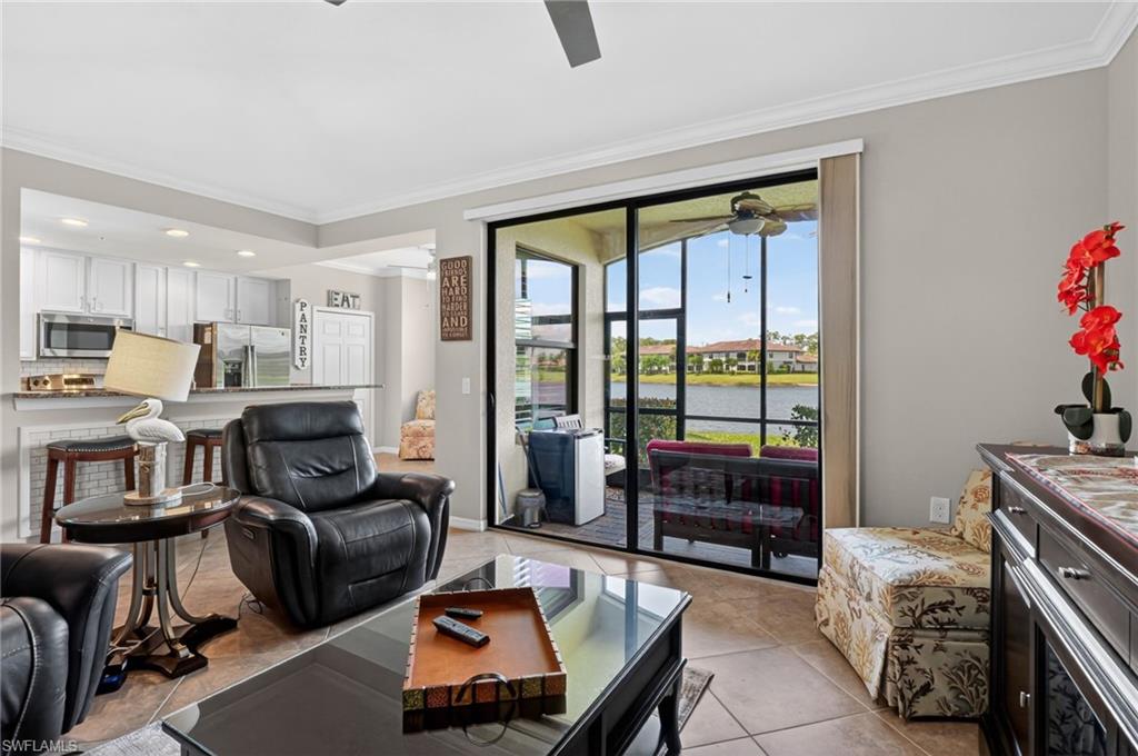 9513 Avellino Way, Unit 2014 Naples, FL 34113 - Photo 30 of 41 a living room with furniture and a floor to ceiling window