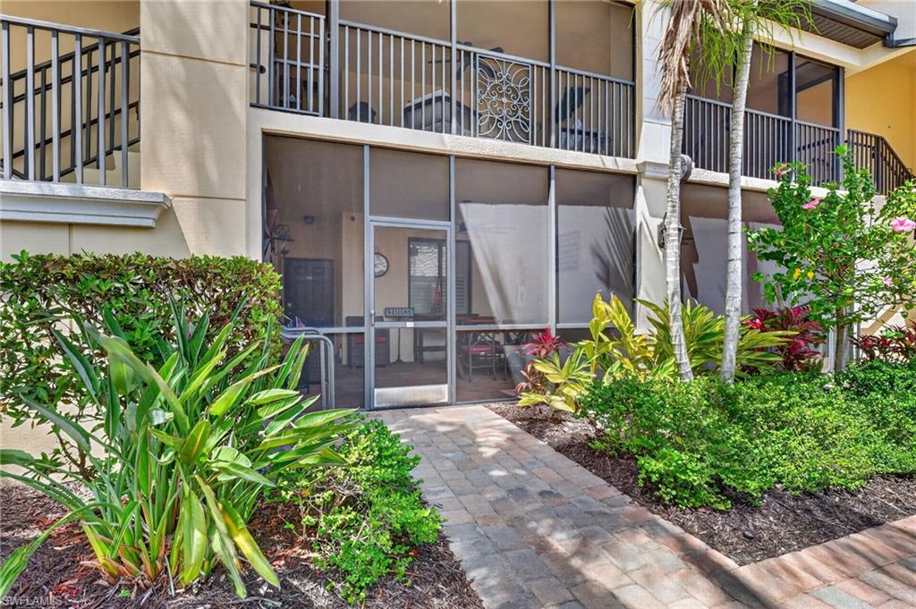9513 Avellino Way, Unit 2014 Naples, FL 34113 - Photo 31 of 41 a view of a pathway of a house with a garden