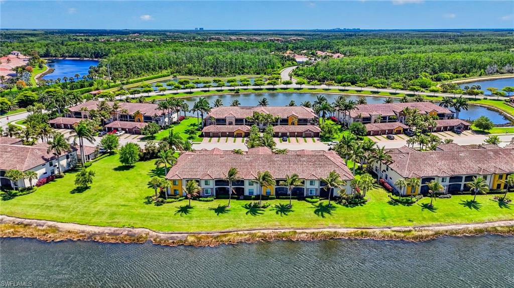 9513 Avellino Way, Unit 2014 Naples, FL 34113 - Photo 38 of 41 front view of a house with a garden and trees
