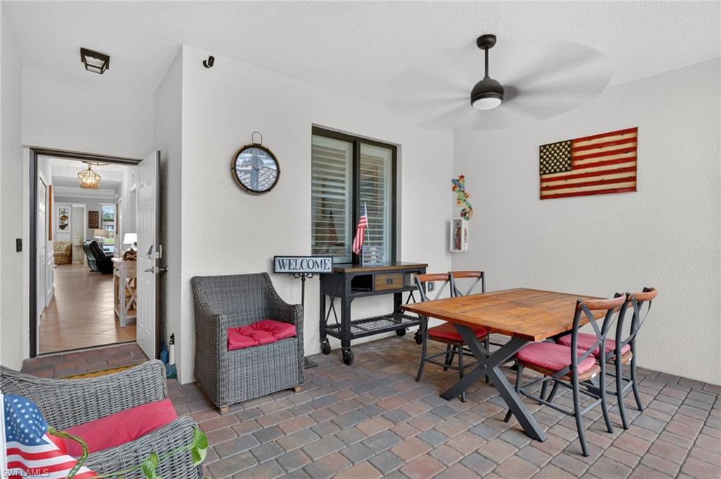 9513 Avellino Way, Unit 2014 Naples, FL 34113 - Photo 5 of 41 a living room with furniture and musical instruments