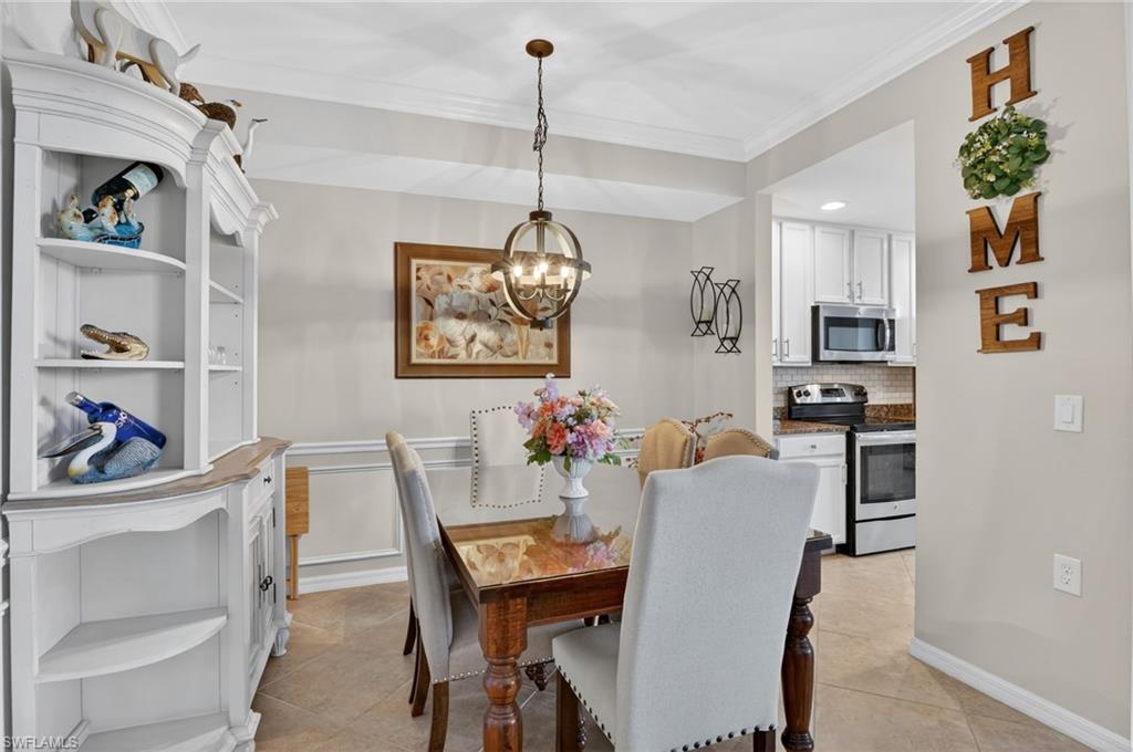 9513 Avellino Way, Unit 2014 Naples, FL 34113 - Photo 6 of 41 a view of a dining room with furniture and chandelier