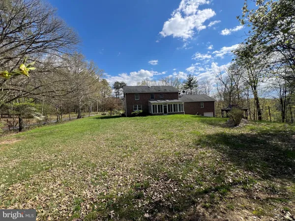 a view of house with yard
