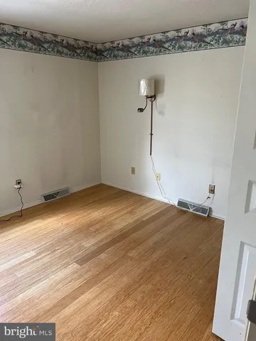 an empty room with a fireplace and windows