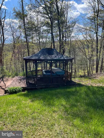 a view of a house with a yard table and chairs