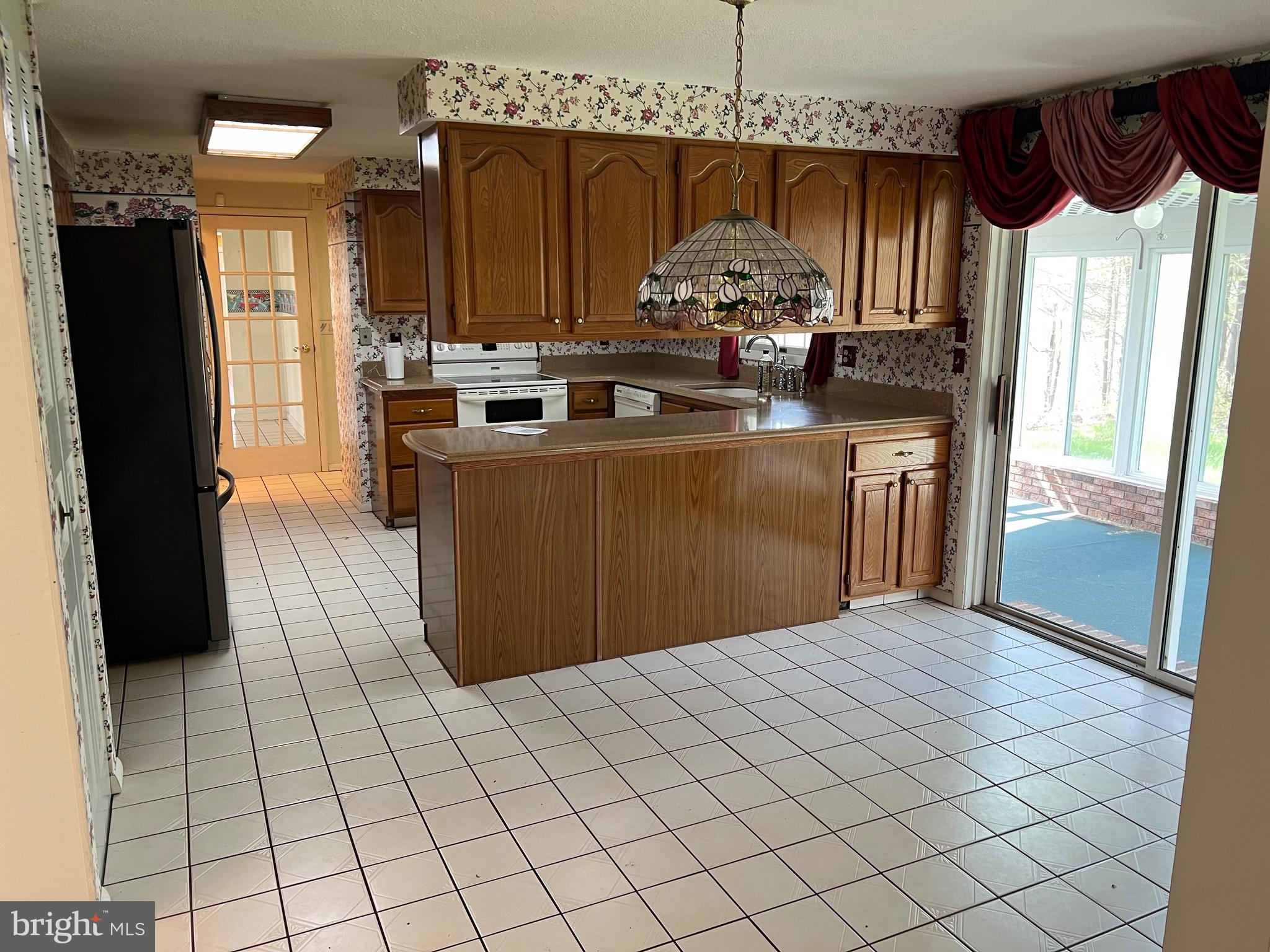 17702 Maniford Road Southeast Oldtown, MD 21555 - Photo 8 of 46 a kitchen with stainless steel appliances kitchen island granite countertop a refrigerator and a stove