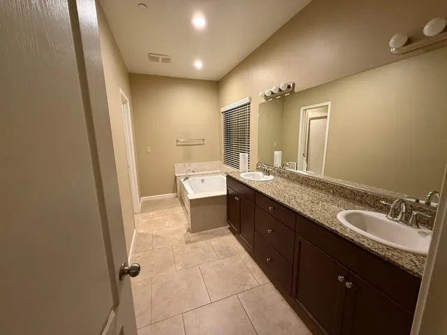 a bathroom with a tub and a shower