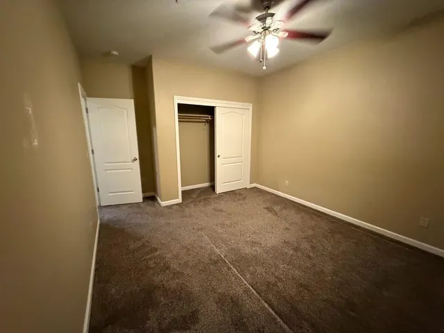 a bathroom with a granite countertop sink a mirror and shower