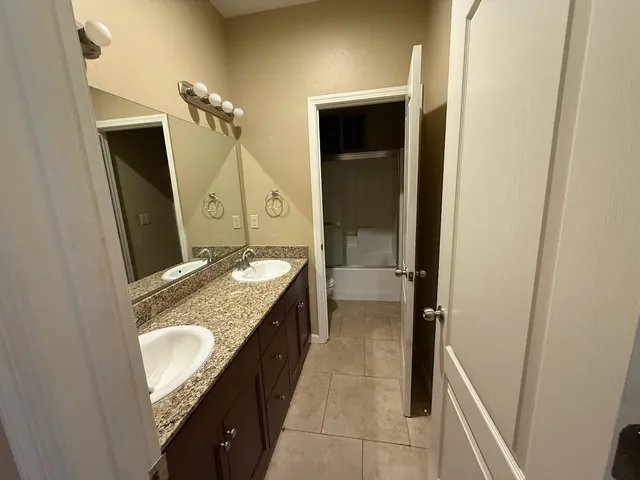 a view of an empty room with a ceiling fan and a window